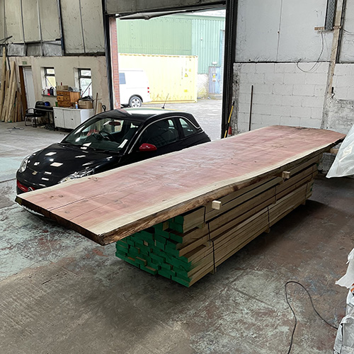 photo of giant sequoia redwood slab next to car